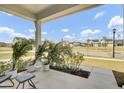 Inviting front porch with potted palm trees and seating, perfect for relaxing at 85 Arrowwood Way, Summerville, SC 29485