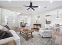 Bright living room with vaulted ceiling, wood floors, and open floor plan to kitchen and dining area at 102 Kapalua Run, Summerville, SC 29483
