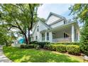 Charming two-story home with mature landscaping and a cozy side porch at 1021 Barfield St, Charleston, SC 29492