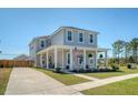 Attractive two-story home with a welcoming covered front porch, complemented by a well-manicured lawn and driveway at 106 Wood Sage Run, Summerville, SC 29485