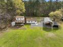 Aerial view of a property featuring a charming home with a deck and a large metal outbuilding at 117 Wernham Ln, Moncks Corner, SC 29461