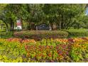 Mira Vista entrance sign surrounded by lush greenery and colorful flowers at 1223 Telfair Way Way, Charleston, SC 29412