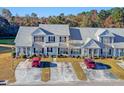 Charming townhome featuring a well-maintained facade, attached parking, and a serene lakeside view at 128 Black River Dr, Summerville, SC 29485