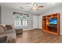 Cozy living room featuring hardwood floors, with lots of natural light, and a ceiling fan at 132 Heather Dr, Summerville, SC 29486