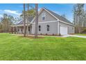 Attractive home with a side-entry garage and a spacious green lawn at 136 Mitch Ln, Holly Hill, SC 29059