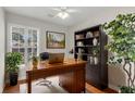 Inviting home office with hardwood floors, a large desk, and natural light from the window at 1362 Kingsford Ln, Mount Pleasant, SC 29466