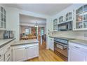 Bright kitchen featuring white cabinetry, modern appliances, and an open view into the dining area at 140 Wampee Curve, Summerville, SC 29485