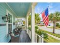 Inviting front porch with comfortable wicker seating, offering a relaxing outdoor space to enjoy the neighborhood at 1543 Watoga Way, Mount Pleasant, SC 29466