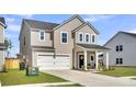 Beautiful two-story house with a well-manicured lawn, attached garage, and a welcoming front porch with seating at 157 Tuscan Sun St, Summerville, SC 29485