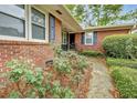 Charming brick home with manicured landscaping and a welcoming front entrance with mature flower bushes at 1636 Pinopolis Rd, Moncks Corner, SC 29461