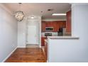 Open kitchen layout with stainless steel appliances, cherry cabinets, and breakfast bar at 1755 Central Park Rd # 3102, Charleston, SC 29412