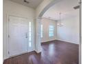 Welcoming foyer with hardwood floors, decorative pillars, and an arched opening leading to the dining room at 189 Weeping Cypress Dr, Moncks Corner, SC 29461