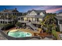 Beautiful backyard featuring a private pool, lounge chairs, and a spacious deck perfect for outdoor entertaining at 212 Ocean Blvd, Isle of Palms, SC 29451