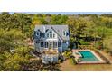 Expansive backyard featuring an inviting pool area, complemented by a deck and screened porch at 2410 Kemway Rd, Johns Island, SC 29455