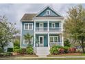Inviting two-story home boasts a charming porch, fresh landscaping, and a welcoming facade at 2447 Louisville St, Charleston, SC 29492
