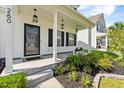 Close-up of a charming front porch with stylish lanterns, neat landscaping, and a welcoming entrance at 260 Dunlin Dr, Summerville, SC 29486