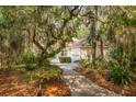 Attractive home exterior nestled among verdant trees, well-maintained landscaping, and a welcoming walkway at 2737 Old Forest Dr, Seabrook Island, SC 29455