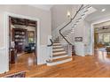 Grand foyer with hardwood floors, staircase and view into the living space at 278 Furman Farm Pl, Daniel Island, SC 29492