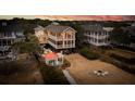 Beautiful elevated beach home featuring a gazebo and fire pit area at 2906 Palm Blvd, Isle of Palms, SC 29451