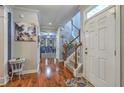Inviting foyer with gleaming hardwood floors, staircase, and stylish decor at 3073 Moonlight Dr, Charleston, SC 29414