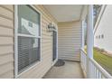 Welcoming covered front porch with white railings and space for outdoor seating at 3073 Moonlight Dr, Charleston, SC 29414