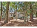 Charming home nestled among mature trees, featuring a welcoming entrance and neutral siding at 3180 Pine Needle Ln, Seabrook Island, SC 29455