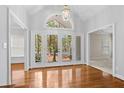 Bright foyer with hardwood floors, transom window, and glass double doors to the exterior at 3180 Pine Needle Ln, Seabrook Island, SC 29455