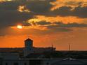 Sunset cityscape view features an orange sky and multiple buildings at 330 Concord St # 9C, Charleston, SC 29401