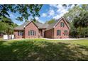 Traditional brick home featuring a lush green lawn and mature trees, creating a serene and inviting curb appeal at 3708 Colonel Vanderhorst Cir, Mount Pleasant, SC 29466
