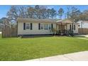 Single story home boasts curb appeal with its neatly kept lawn and classic design at 4701 Ivydale Dr, North Charleston, SC 29405