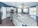Modern kitchen features granite countertops, stainless steel appliances, white cabinets, and a breakfast bar at 505 Kilarney Rd, Summerville, SC 29483