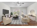Stylishly staged living room with a ceiling fan and plenty of natural light at 874 Colony Drive # B19, Charleston, SC 29407