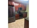 Functional kitchen with dark wood cabinetry, granite counters, and stainless steel appliances at 9028 Maple Grove Dr, Summerville, SC 29485