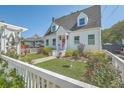 Beautifully landscaped front yard with a charming white picket fence and inviting walkway leading to the home at 928 Ashley Ave, Charleston, SC 29403