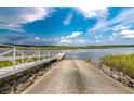 Convenient concrete boat ramp providing easy access to the waterway under a sunny sky at 102 Tidewater Way, Charleston, SC 29492