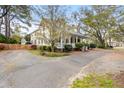 Well-maintained home featuring a charming porch, surrounded by vibrant greenery and a driveway at 1034 Orangeburg Rd, Summerville, SC 29483