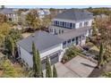 An expansive exterior view of home, showcasing the garage, driveway and surrounding greenery at 111 Ithecaw Creek St, Charleston, SC 29492