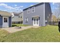 View of the backyard and patio, featuring a fire pit, and an entrance to the home with a French door at 117 Red Leaf Blvd, Moncks Corner, SC 29461