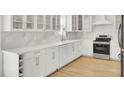 View of a kitchen featuring white cabinets, wine rack, stone countertops, and stainless steel appliances at 117 Red Leaf Blvd, Moncks Corner, SC 29461