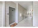 Apartment hallway features neutral tones, multiple doors, and staircase access at 1300 Park West Blvd # 517, Mount Pleasant, SC 29466