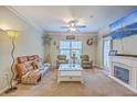Inviting living room with a fireplace, comfortable seating, and a ceiling fan at 1300 Park West Blvd # 517, Mount Pleasant, SC 29466