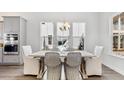 Dining room with a view of the backyard through the large windows and modern furnishing at 1435 Clay Field Trl, Summerville, SC 29485