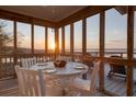 Enjoy marsh views from this screened porch, perfect for dining or relaxing with tranquil scenery at 1504 Forrest Ave, Folly Beach, SC 29439