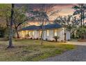 Charming single-story home featuring a brick exterior, well-manicured lawn, and mature trees at 1532 Hutton Pl, Charleston, SC 29407
