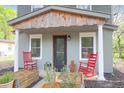 Inviting front porch with rocking chairs and string lights, creating a cozy outdoor space at 1617 Balsam St, Charleston, SC 29407