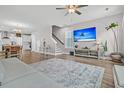 Open-concept living room with television, dining area, and staircase at 1675 Indy Dr, North Charleston, SC 29405