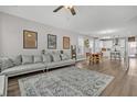 Open-concept living room with modern furnishings, flowing into a bright kitchen and dining area at 1675 Indy Dr, North Charleston, SC 29405