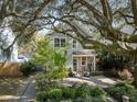 Charming two-story home with inviting brick patio and lush landscaping underneath mature tree at 2187 Annie Laura Ln, Mount Pleasant, SC 29466