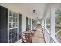 Inviting covered front porch with seating and views of the surrounding neighborhood at 220 New Oak Ln, Moncks Corner, SC 29461