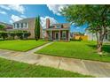 Beautiful home showcasing lush green lawn, sidewalk, and mature trees in the front yard at 226 Killarney Trl, Moncks Corner, SC 29461